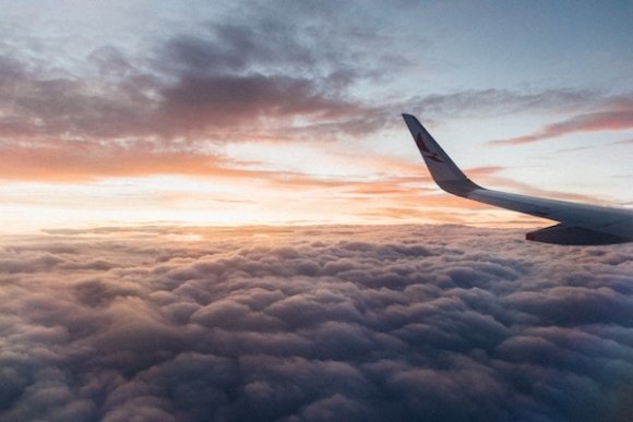 sunset view of clouds from an airplane window seat